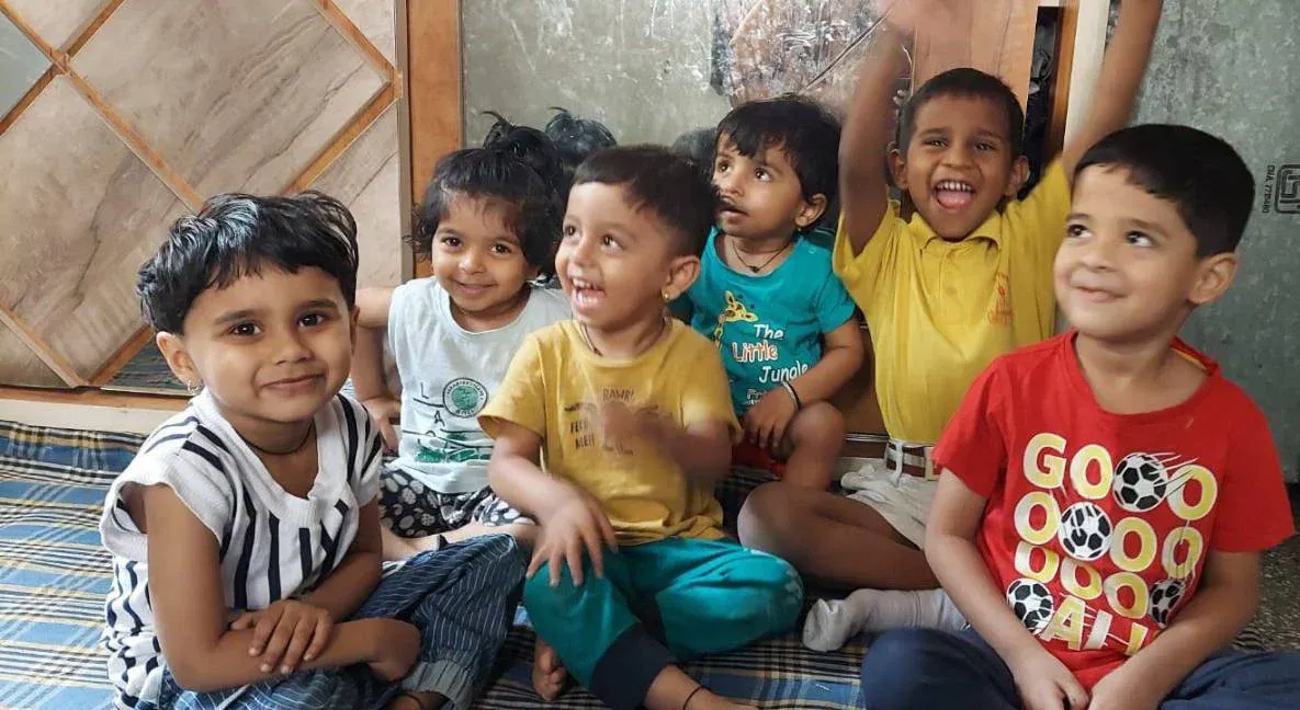 Six happy children smiling and laughing together at Maza Ghar Day Care in Katraj, Pune