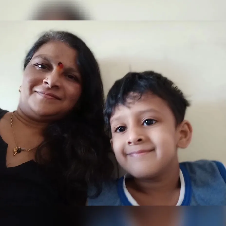 The Maza Ghar caretaker smiling with one of the children