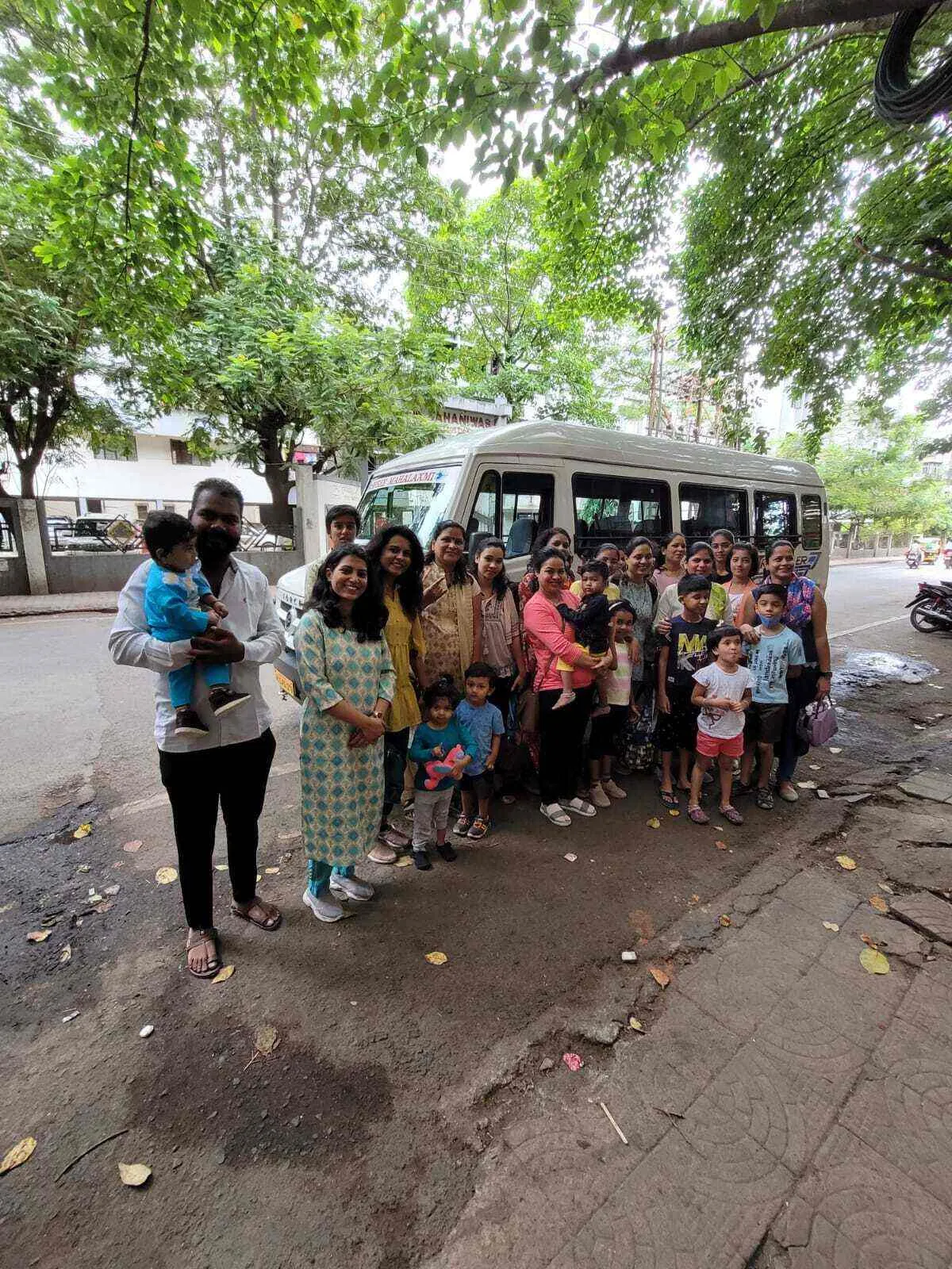 Maza Ghar children and parents gathered by the bus for a daycare picnic outing